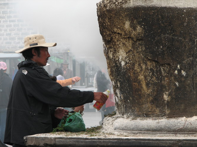 Tibetan man making offerings in front of the Jokhang temple. Lhasa, Tibet.